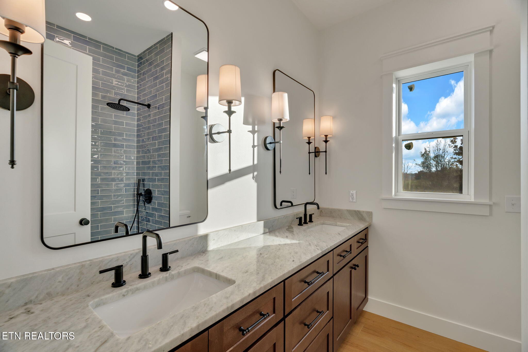 245 Pates Hill Road Mosheim, TN 37818 - Photo 26 of 35 a bathroom with double vanity sink and a mirror