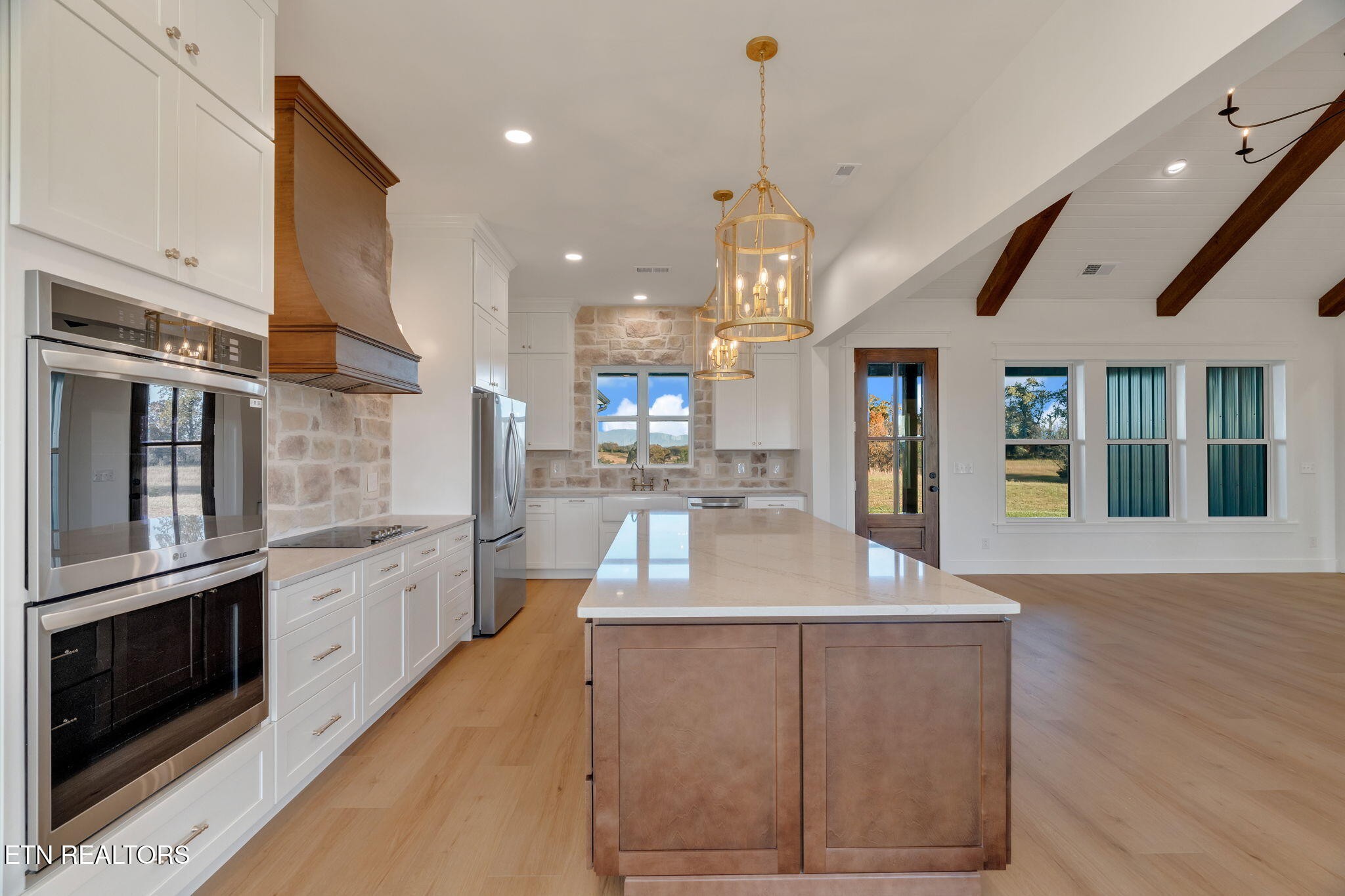 245 Pates Hill Road Mosheim, TN 37818 - Photo 8 of 35 a kitchen with stainless steel appliances granite countertop a refrigerator a oven a sink and a dining table with wooden floor