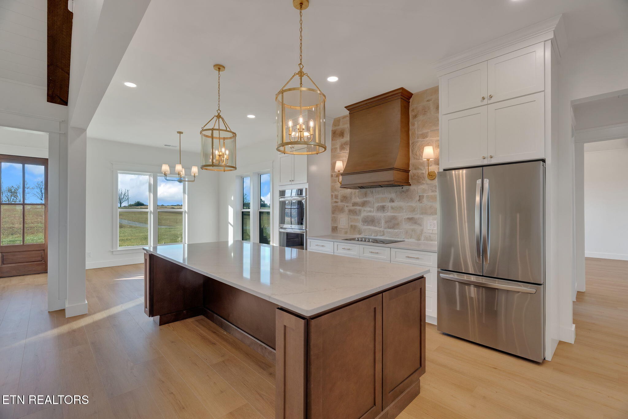 245 Pates Hill Road Mosheim, TN 37818 - Photo 9 of 35 a kitchen with kitchen island a counter top space stainless steel appliances and a chandelier