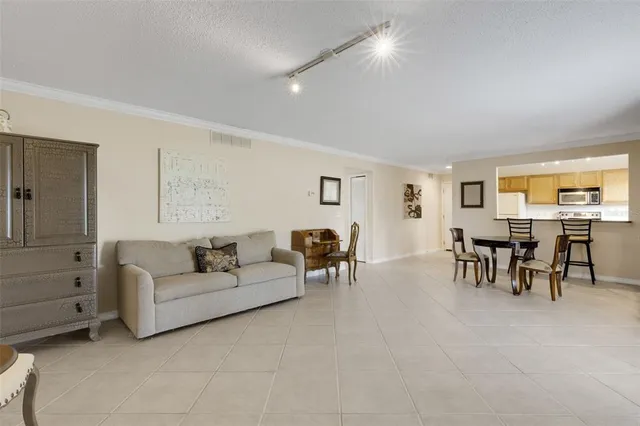 a view of a livingroom with furniture a flat screen tv and outdoor seating
