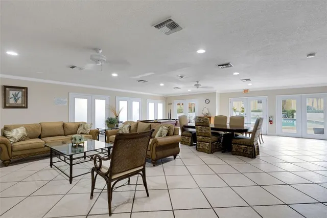 a living room with furniture a flat screen tv and a table