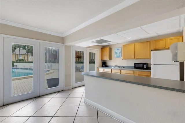 a view of swimming pool with outdoor seating and palm tree