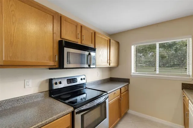 a kitchen with stainless steel appliances granite countertop a stove and a microwave