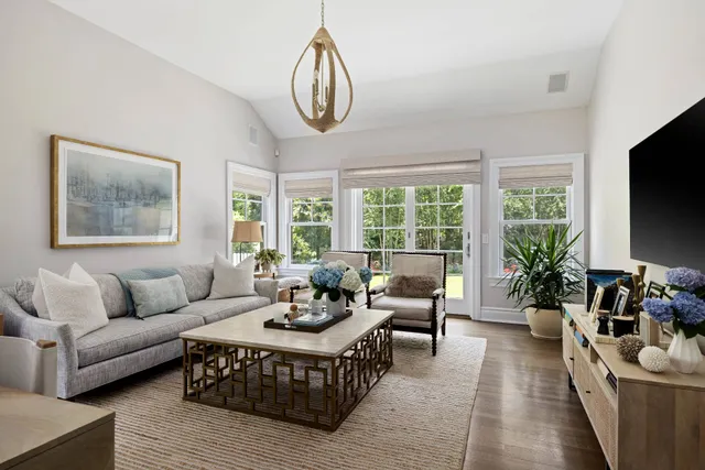 a living room with furniture and large windows