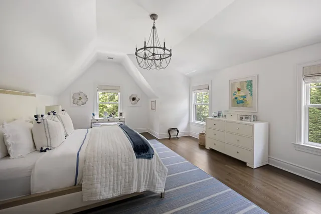 a bathroom with a granite countertop sink mirror vanity and toilet