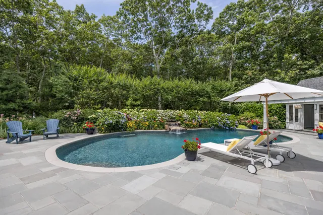 a view of a house with pool and garden
