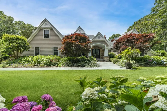a front view of a house with a garden