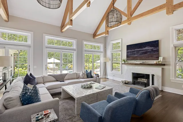 a view of a dining room with furniture large windows and wooden floor