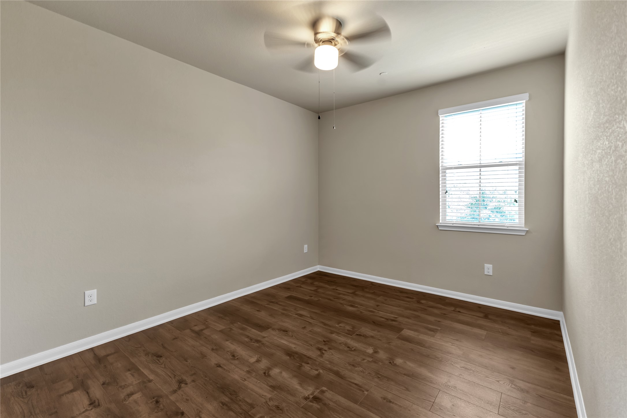 2880 Donnell Drive, Unit 2003 Round Rock, TX 78664 - Photo 23 of 31 Room featuring wood-finish flooring, a ceiling fan with integrated lighting, a window with horizontal blinds, and neutral wall tones