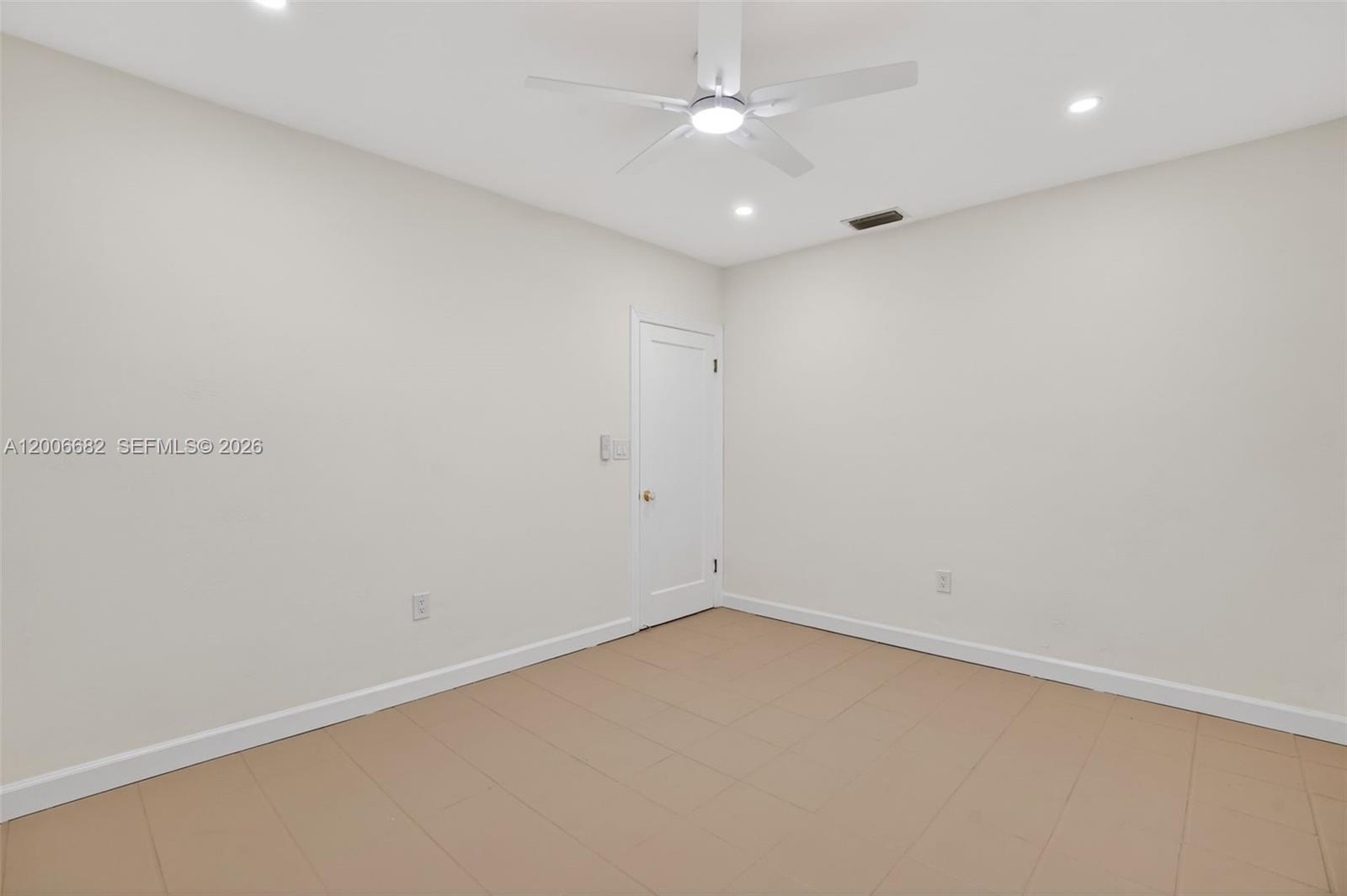 1435 Blue Road Coral Gables, FL 33146 - Photo 19 of 31 an empty room with a ceiling fan and a window