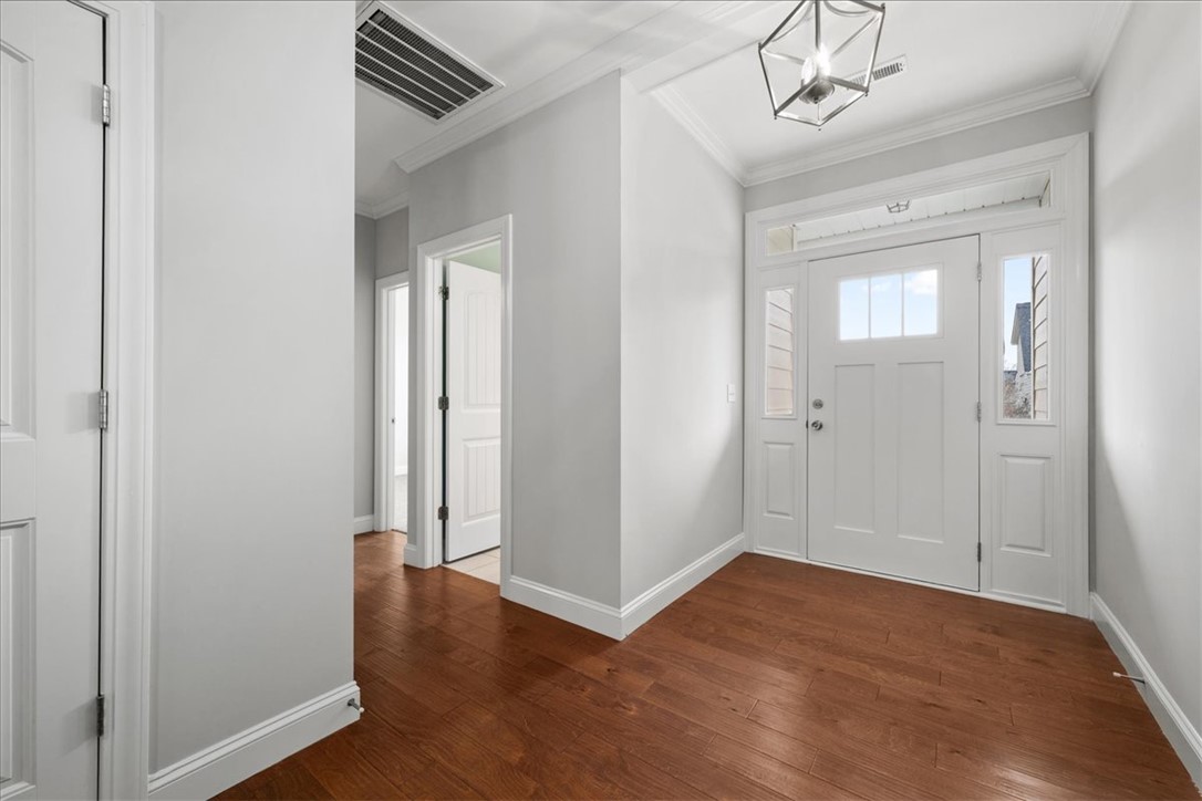 102 Ripplestone Way Anderson, SC 29621 - Photo 3 of 39 A welcoming entry features rich hardwood floors, leading to a pristine white front door framed by elegant sidelights.