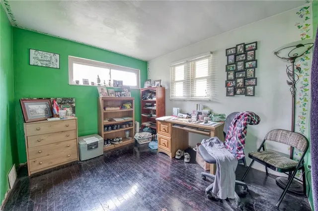 a view of a workspace with furniture and a window