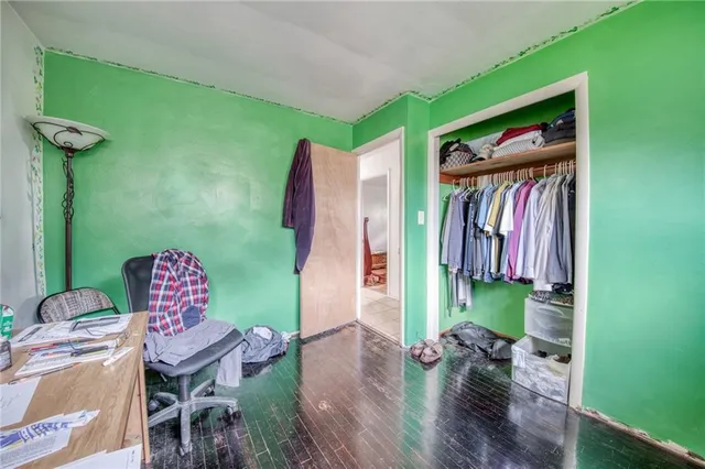 a view of a bedroom with furniture and a book shelf