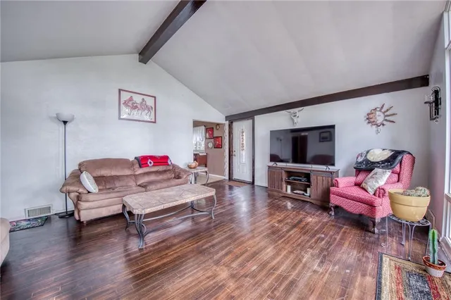 a bedroom with furniture and a flat screen tv