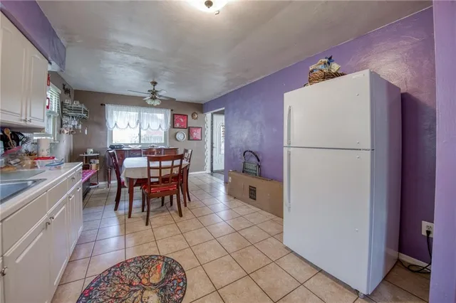 a kitchen with stainless steel appliances a refrigerator a microwave oven a sink and a dining table