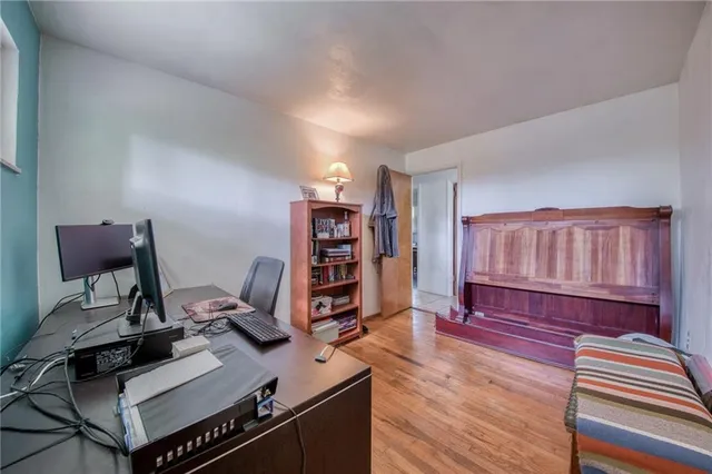 a view of a workspace with furniture and wooden floor