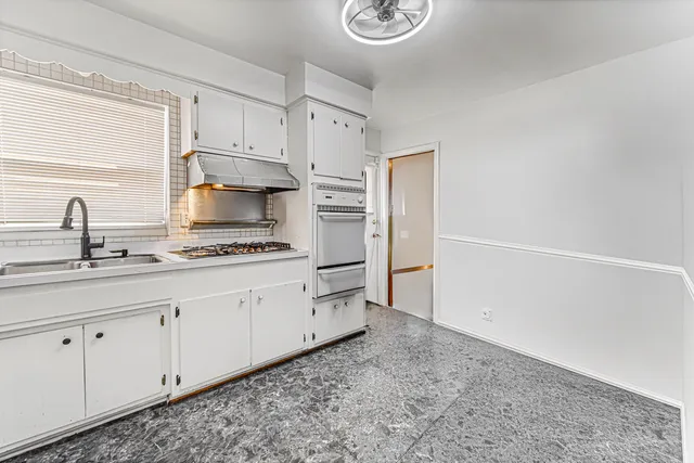 a kitchen with appliances cabinets and a sink