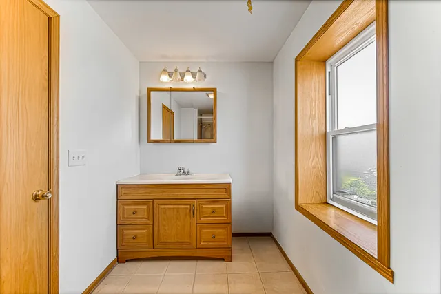 a bathroom with a toilet a sink and a mirror
