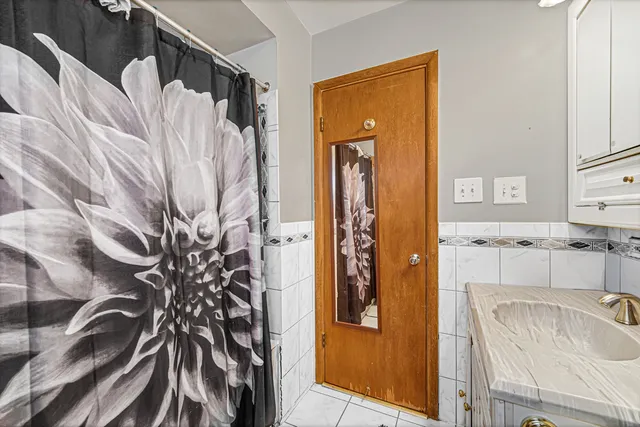 a bathroom with a sink and a shower curtain