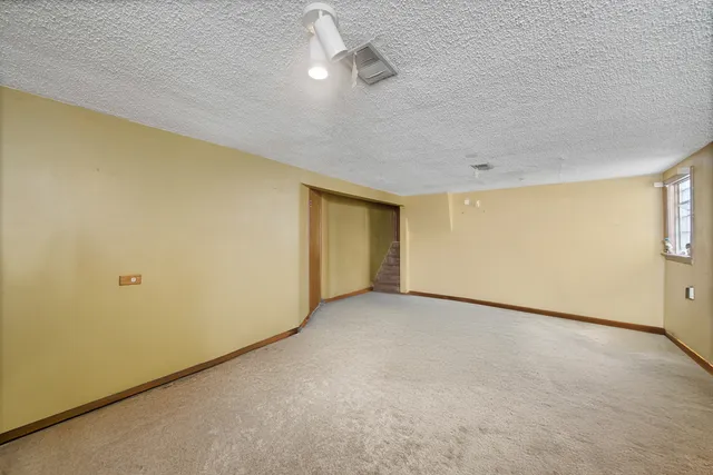 an empty room with a empty space and windows