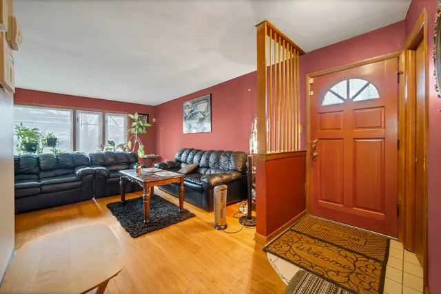 a living room with furniture a window and a flat screen tv