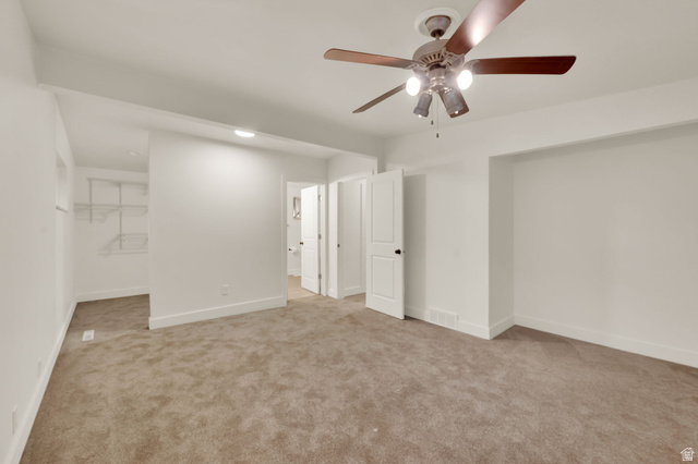 360 400 North Centerville, UT 84014 - Photo 21 of 30 Spacious carpeted room featuring a ceiling fan with integrated lighting, a built-in open closet with wire shelving, and multiple white paneled doors