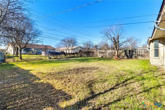 a view of a swimming pool with lawn chairs under an umbrella