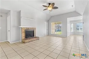 a view of an empty room with a fireplace