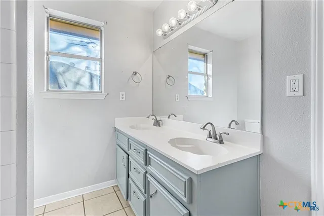 a bathroom with a sink and a mirror