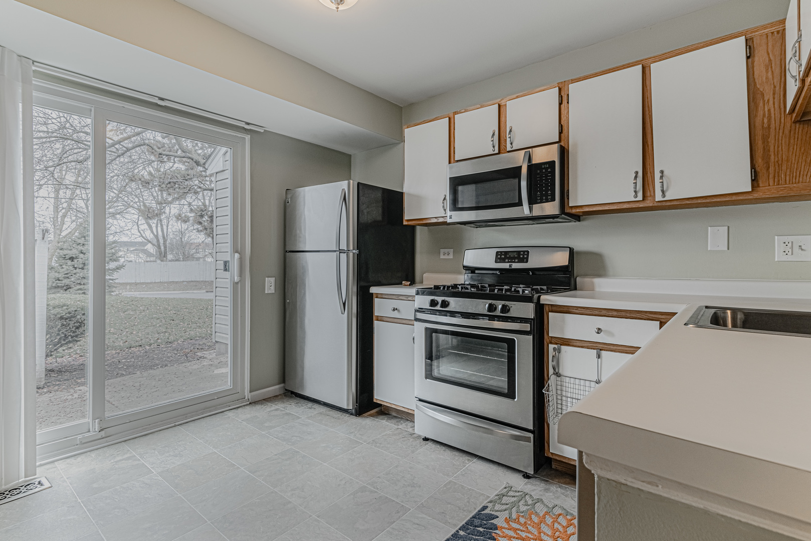 1516 Normantown Road Naperville, IL 60564 - Photo 6 of 20 a kitchen with stainless steel appliances white cabinets and a stove top oven