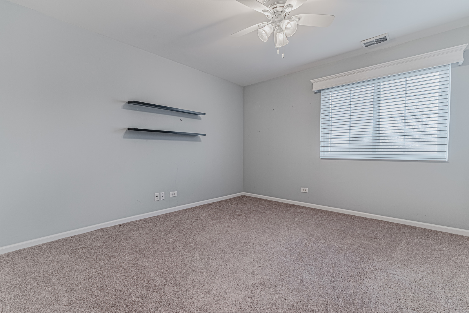 1516 Normantown Road Naperville, IL 60564 - Photo 9 of 20 an empty room with a chandelier fan and windows