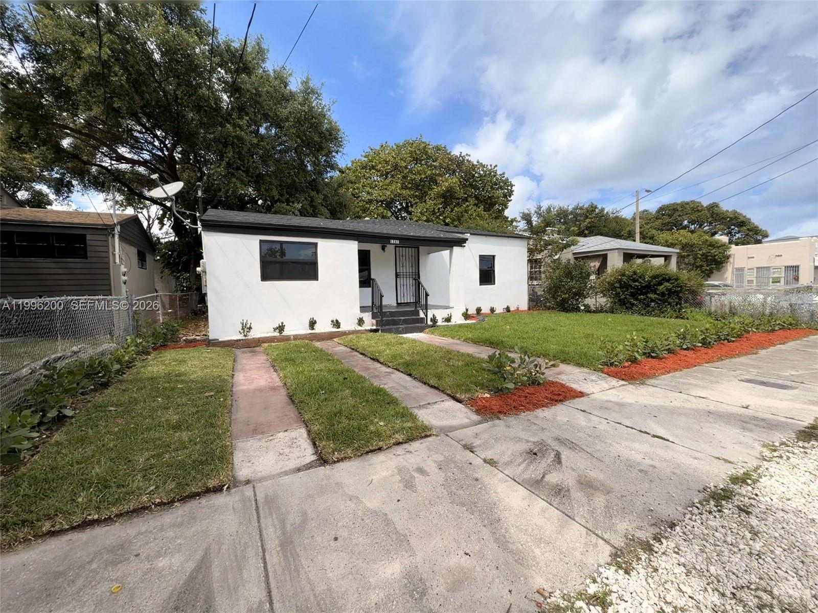 1261 Northwest 45th Street Miami, FL 33142 - Photo 1 of 95 a front view of a house with yard