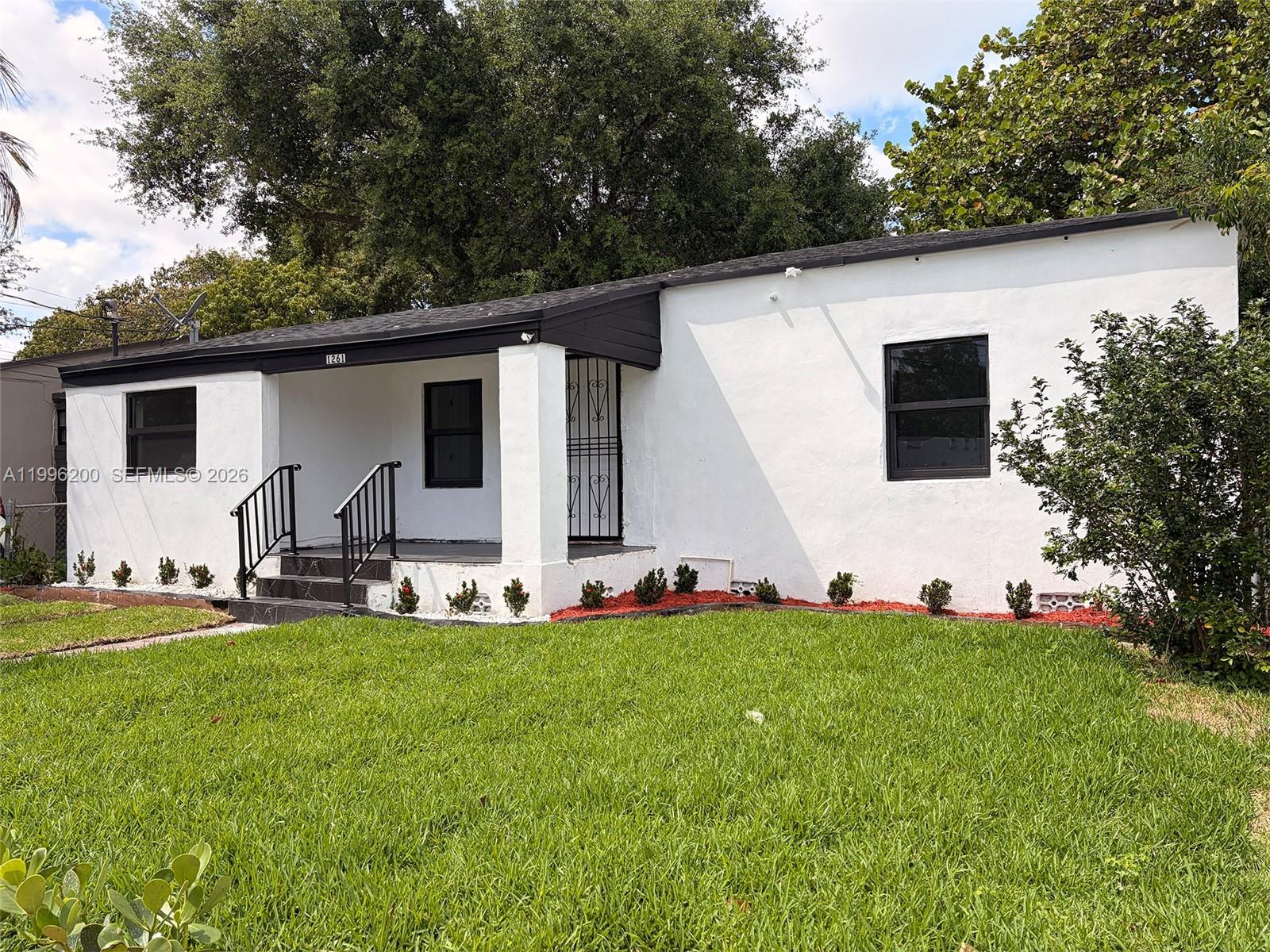 1261 Northwest 45th Street Miami, FL 33142 - Photo 20 of 95 a view of a house with backyard sitting area and garden