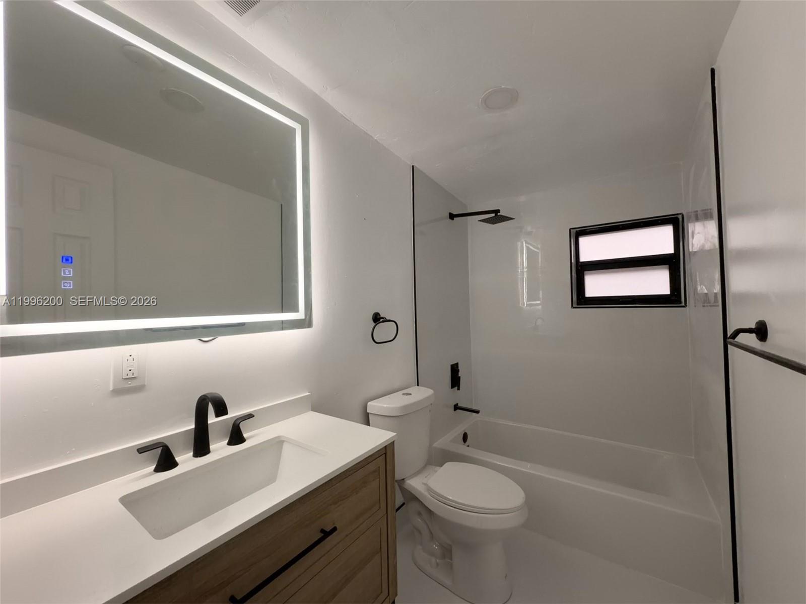 1261 Northwest 45th Street Miami, FL 33142 - Photo 28 of 95 a bathroom with a sink a toilet and shower