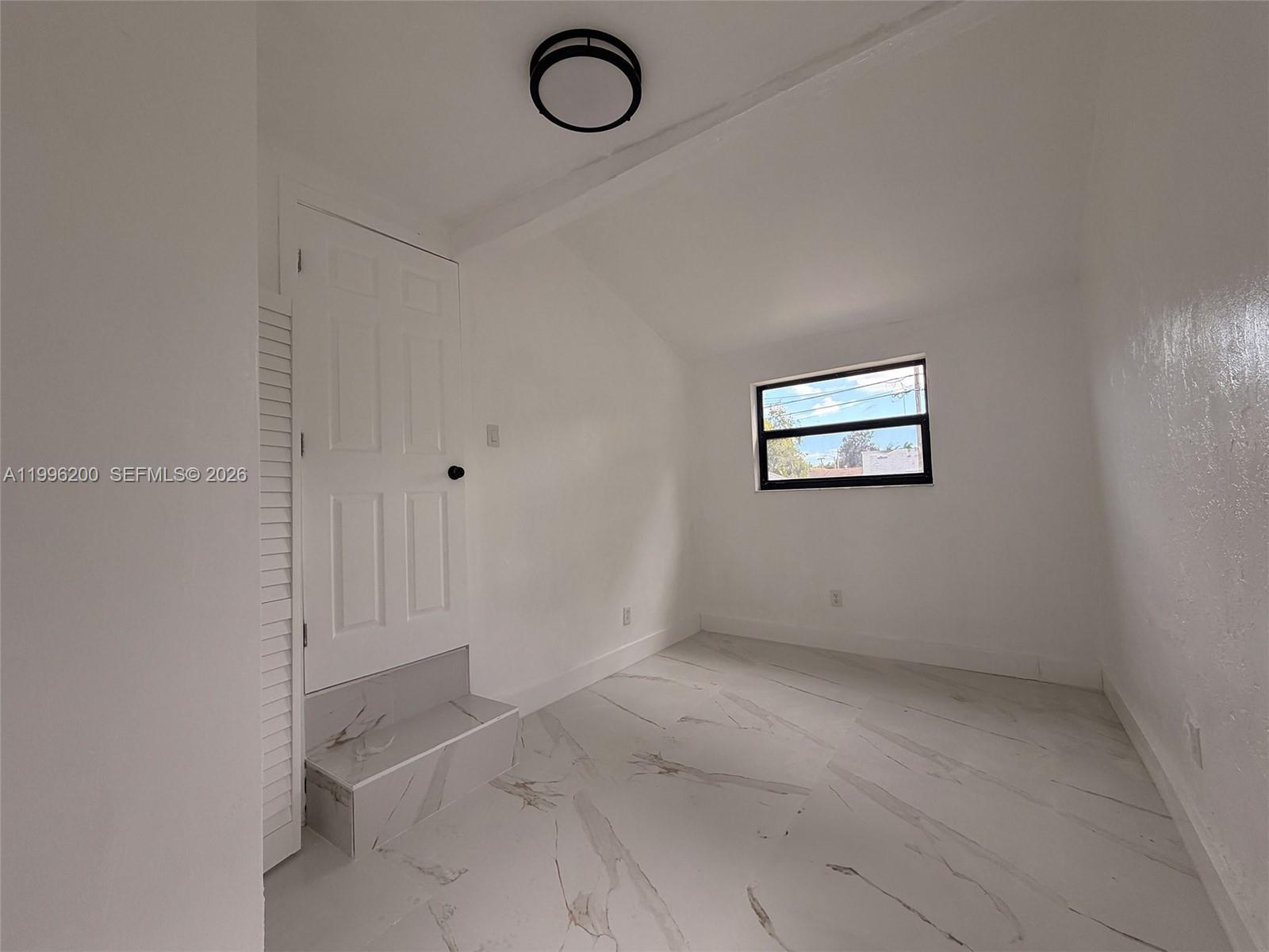 1261 Northwest 45th Street Miami, FL 33142 - Photo 29 of 95 a view of room with window and ceiling fan