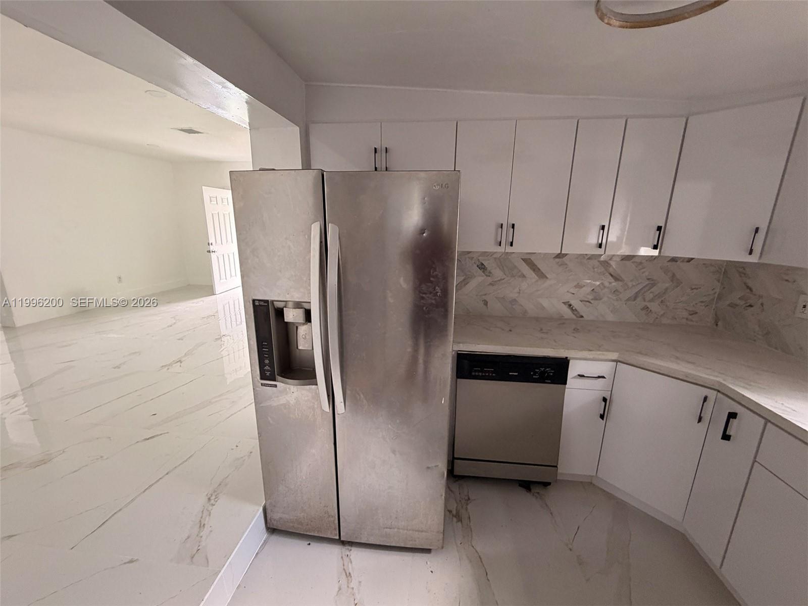 1261 Northwest 45th Street Miami, FL 33142 - Photo 42 of 95 a kitchen with refrigerator and cabinets