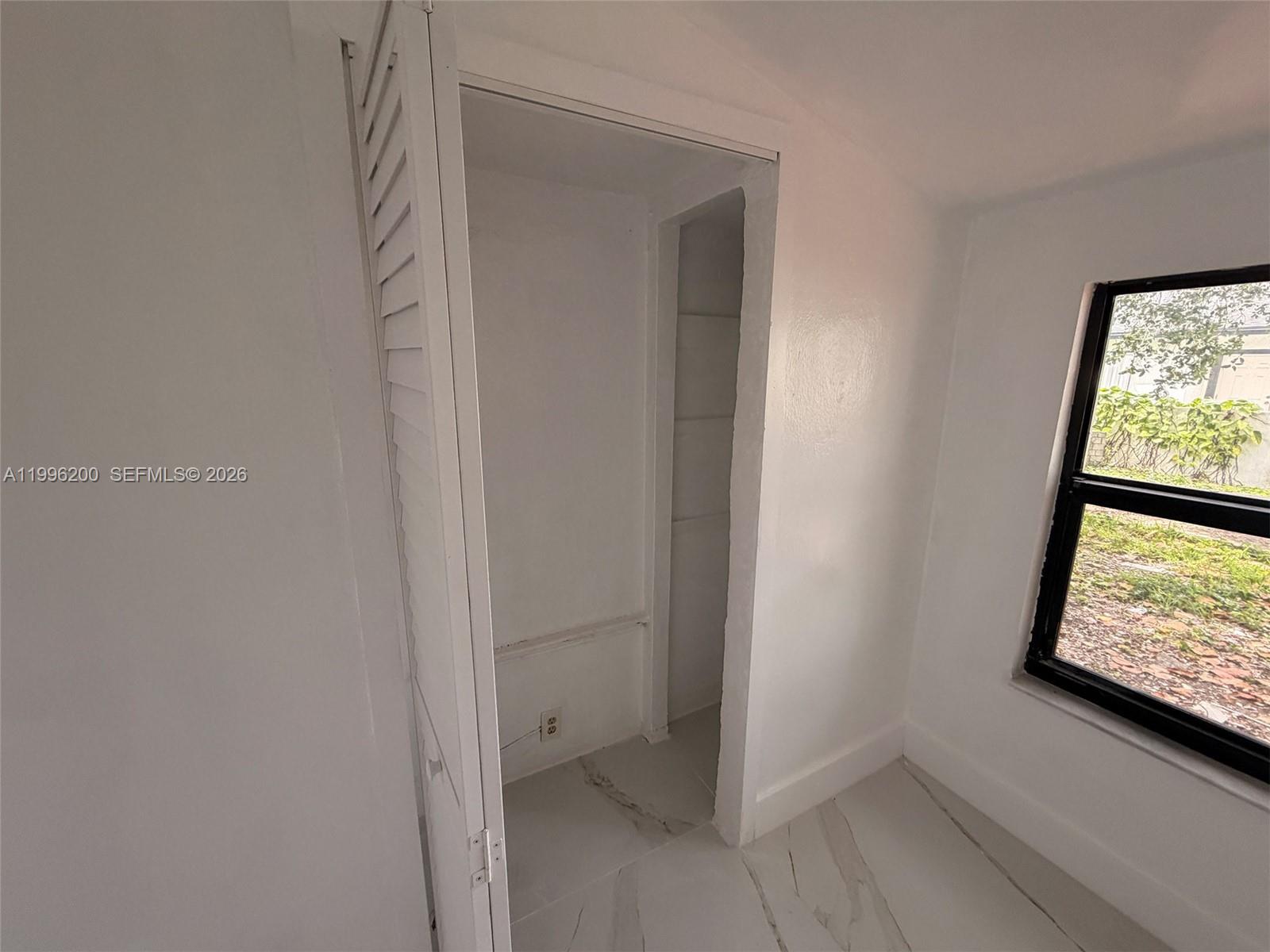 1261 Northwest 45th Street Miami, FL 33142 - Photo 66 of 95 a view of an empty room and window