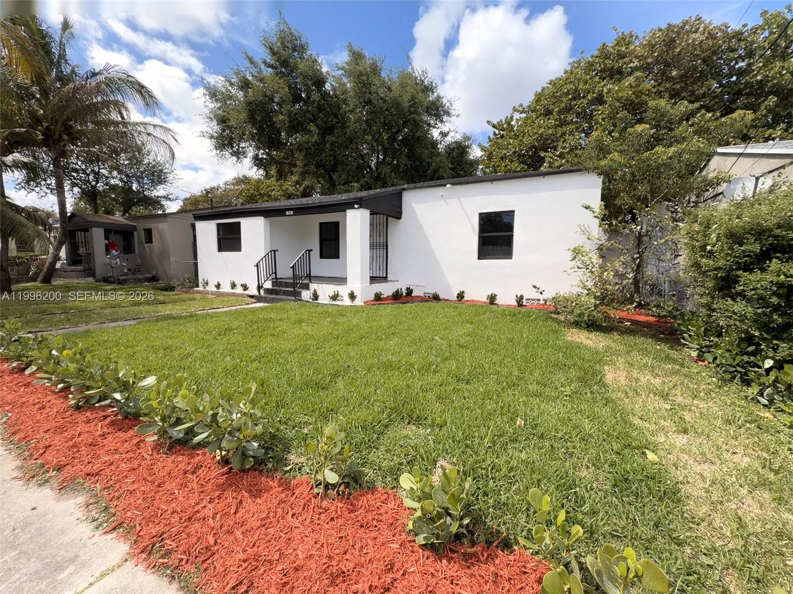 1261 Northwest 45th Street Miami, FL 33142 - Photo 8 of 95 a house view with a sitting space and garden