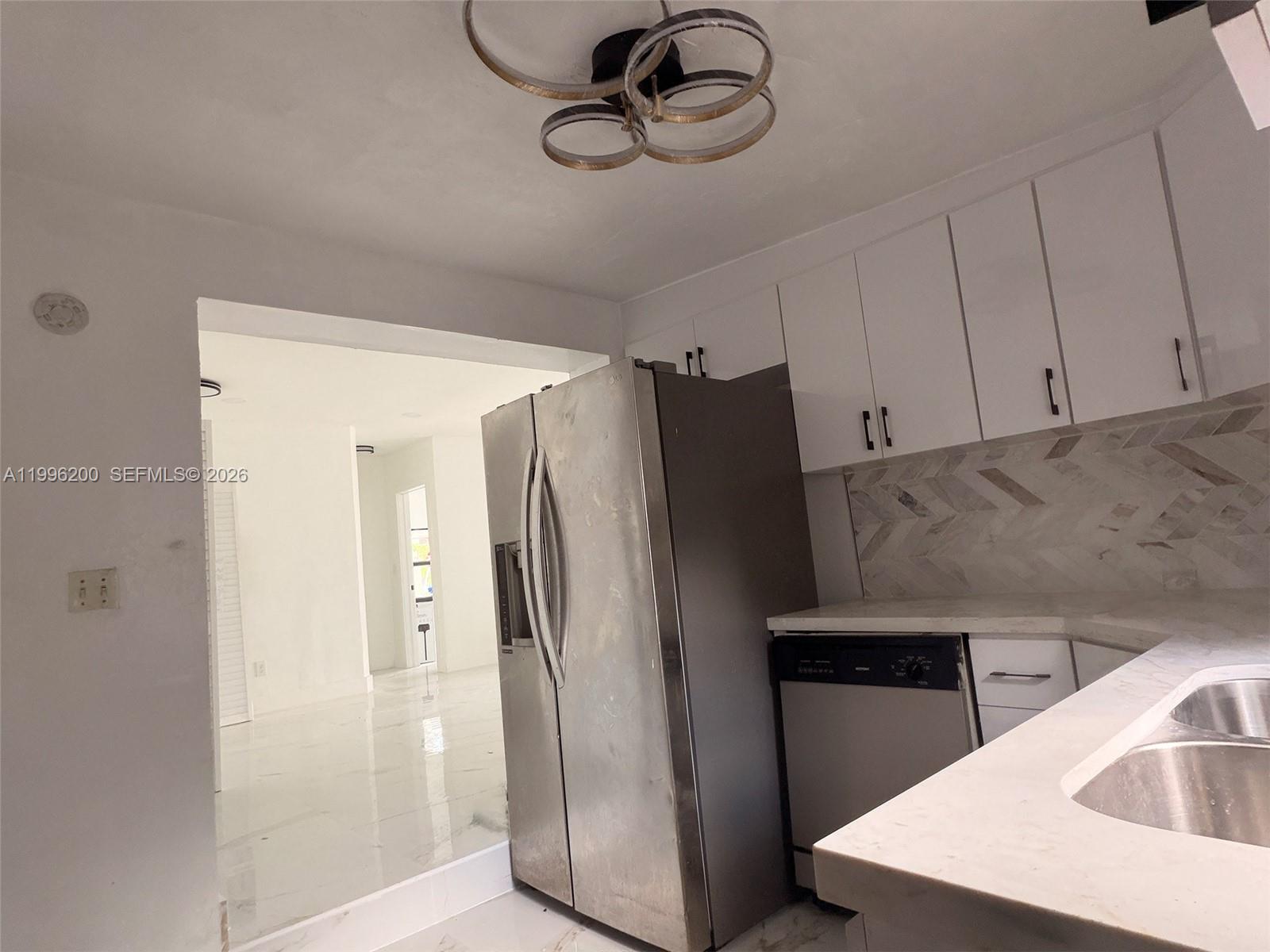 1261 Northwest 45th Street Miami, FL 33142 - Photo 82 of 95 a kitchen with a refrigerator and countertop