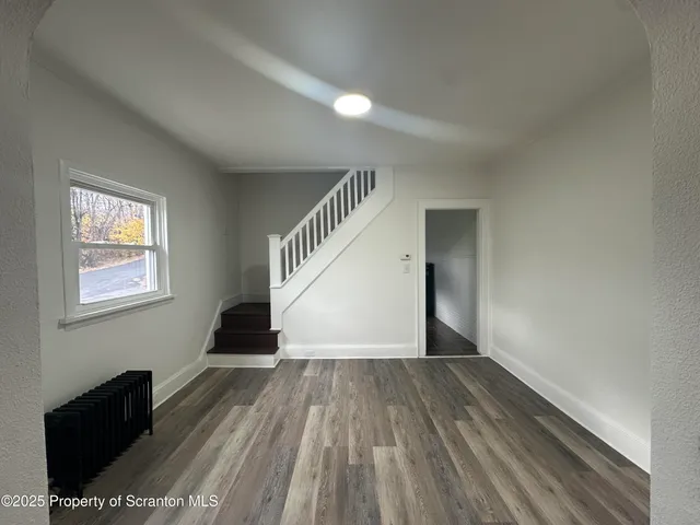 a view of entryway with wooden floor
