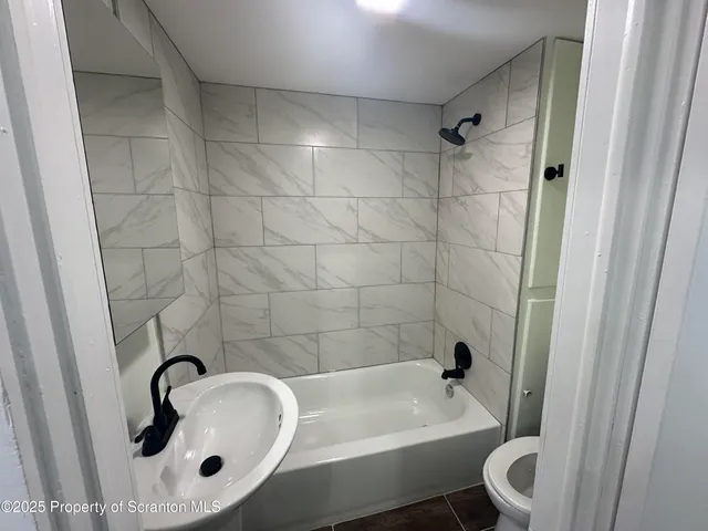 a bathroom with a sink a toilet and a bathtub