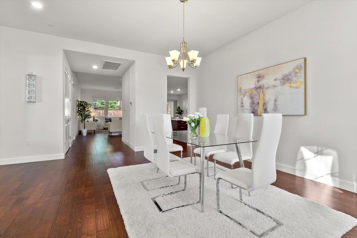 7842 Cinnamon Way Gilroy, CA 95020 - Photo 14 of 51 a view of a dining room with furniture wooden floor and a chandelier