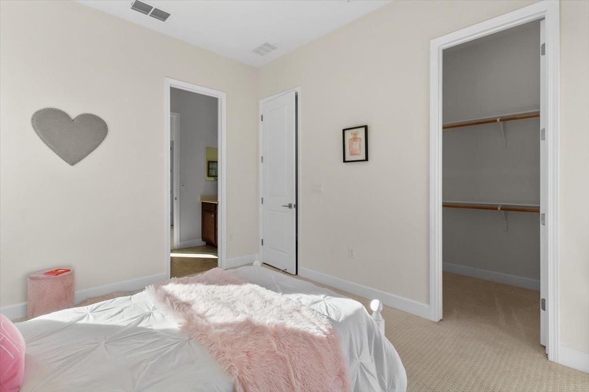 7842 Cinnamon Way Gilroy, CA 95020 - Photo 30 of 51 a bedroom with a bed and a cabinets