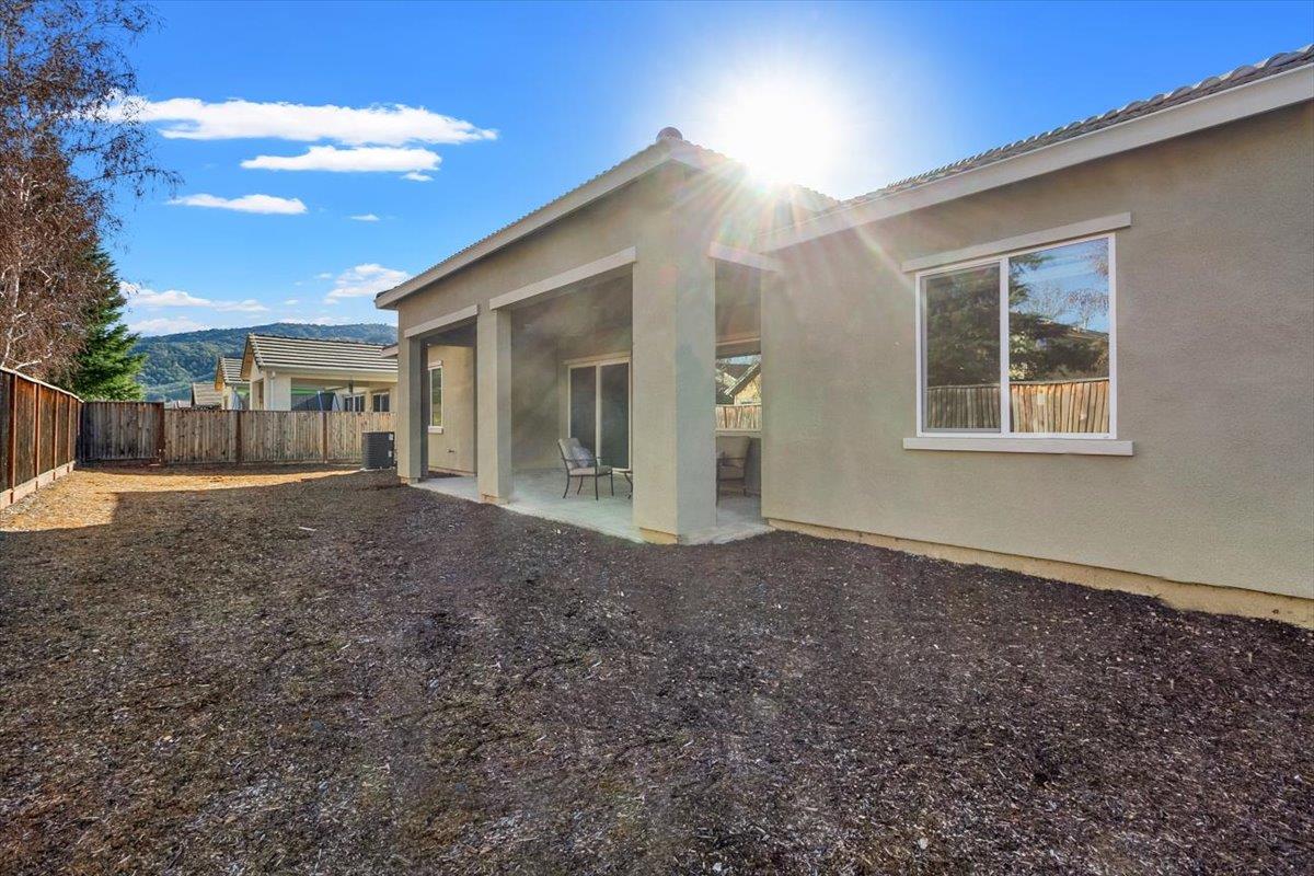 7842 Cinnamon Way Gilroy, CA 95020 - Photo 35 of 51 a view of a house with backyard and a tree