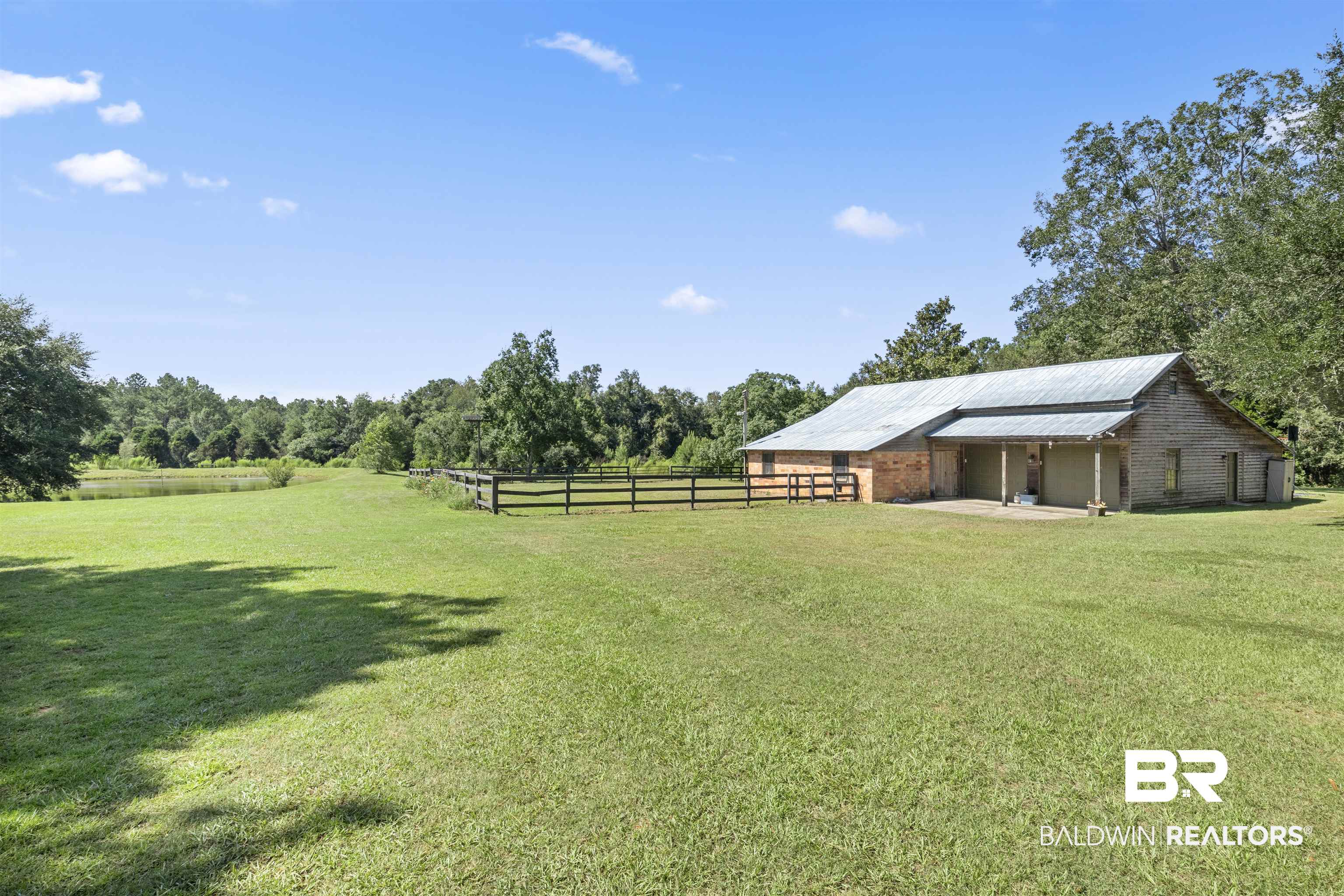 15100 Vasko Road Silverhill, AL 36576 - Photo 34 of 51 View of yard with a rural view. This is in the middle of the 10-acre property and overlooks the stocked pond.