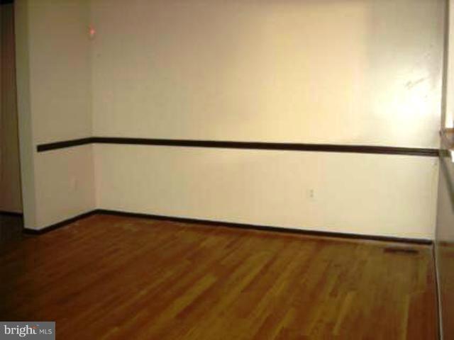 12103 Apache Tears Circle Laurel, MD 20708 - Photo 10 of 11 a view of an empty room and wooden floor