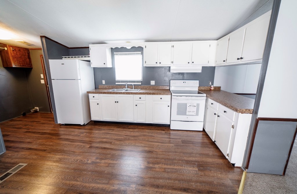 10 McClure Road Seale, AL 36875 - Photo 6 of 23 a kitchen with white cabinets and white appliances