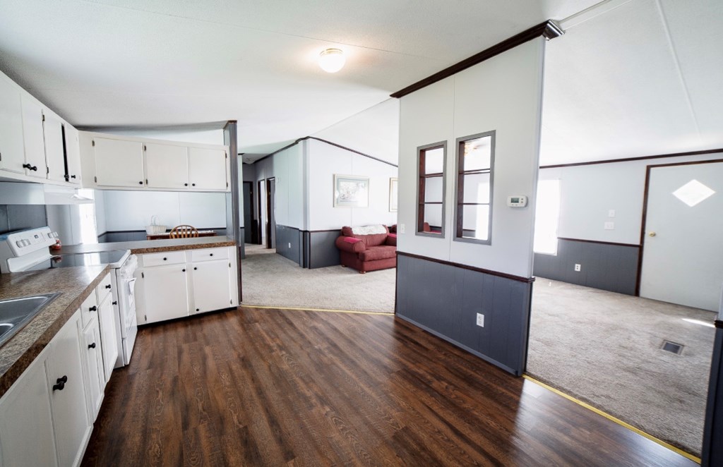 10 McClure Road Seale, AL 36875 - Photo 8 of 23 a kitchen with granite countertop a sink cabinets and wooden floor