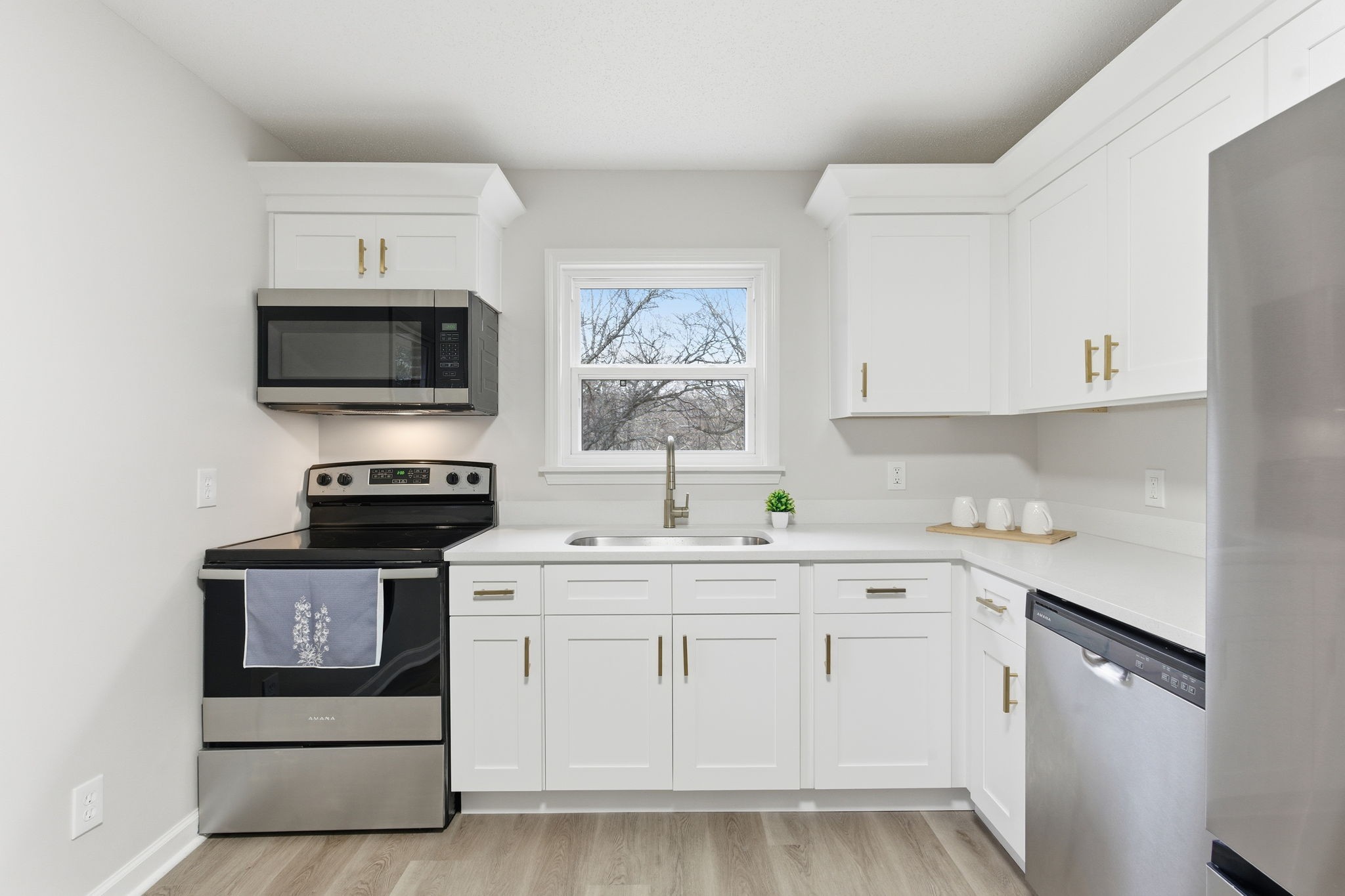 1067 Simms Heights Road Kingston Springs, TN 37082 - Photo 4 of 13 a kitchen with white cabinets stainless steel appliances and sink