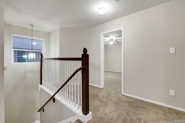 a view of a hallway with staircase
